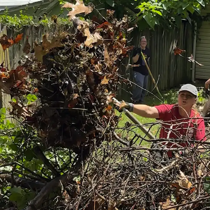 Jennifer shovel full of leaves for Rock the Block
